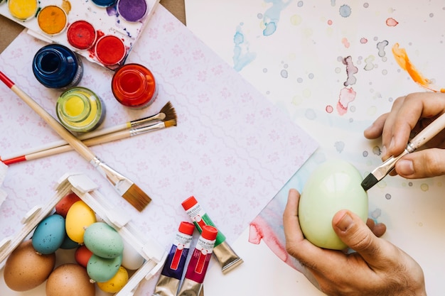 Hand coloring Easter egg in workshop