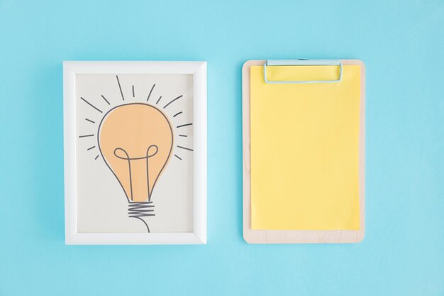 Hand drawn light bulb frame and clipboard with yellow paper