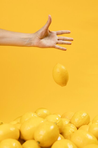 Hand dropping organic lemon