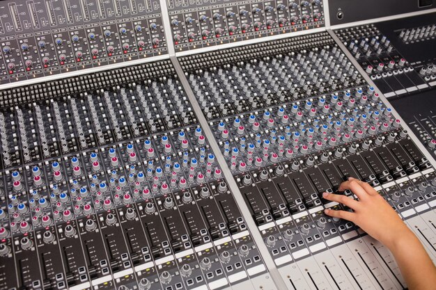 Hand of a female student using sound mixer