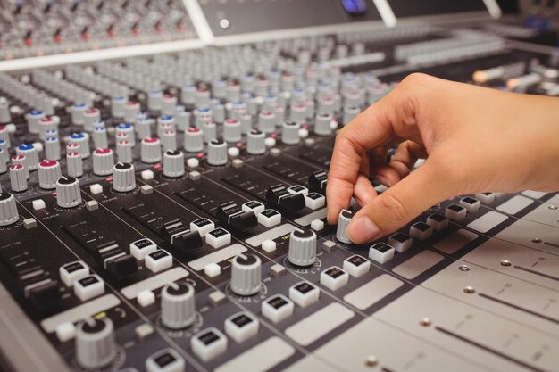 Hand of a female student using sound mixer