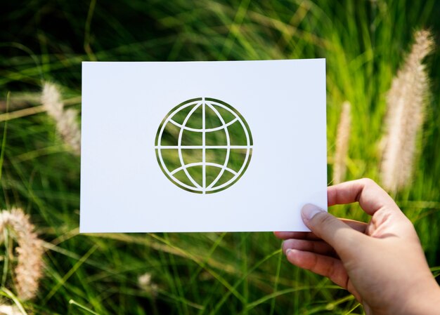 Hand Hold Globe Paper Carving with Grass Background