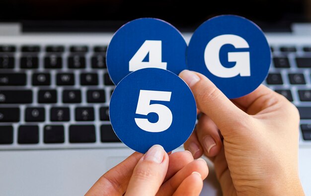 Hand holding 4 and 5g stickers
