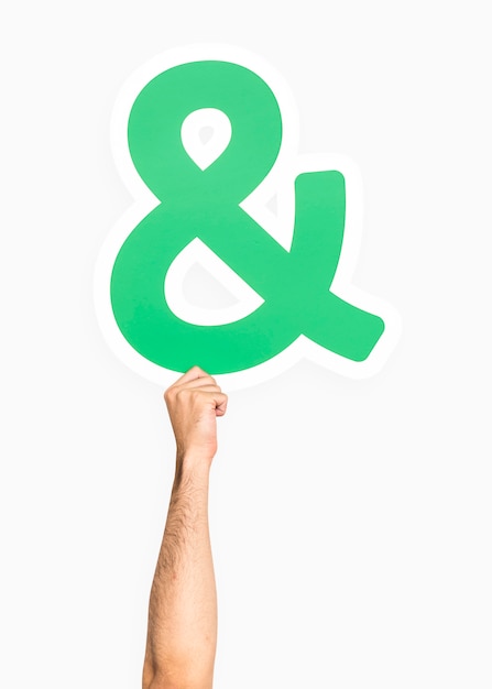 Free photo hand holding ampersand symbol