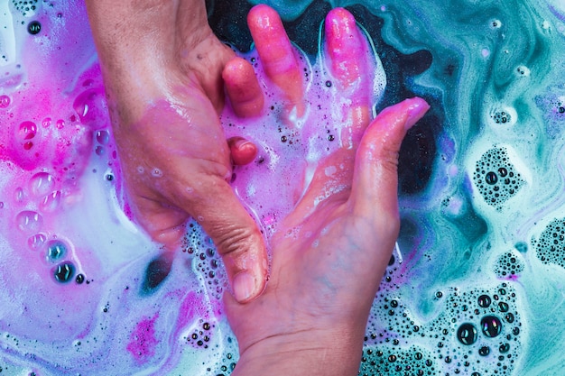 Hand holding another hand in water