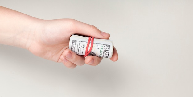 hand holding back-notes tied with rubber band