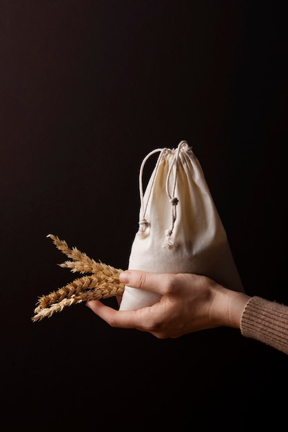 Hand holding bag and grains