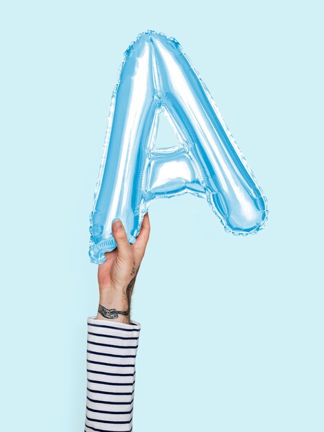 Hand holding balloon letter A