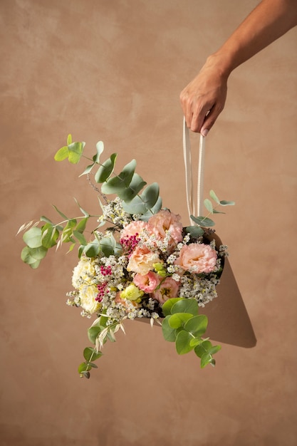 Hand holding beautiful boho flowers arrangement