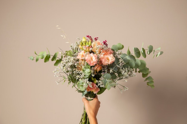 Hand Holding Beautiful Flowers Bouquet