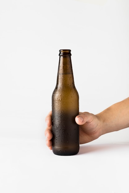 Hand holding beer bottle