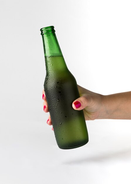 Hand holding beer bottle