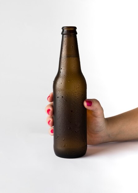 Hand holding beer bottle