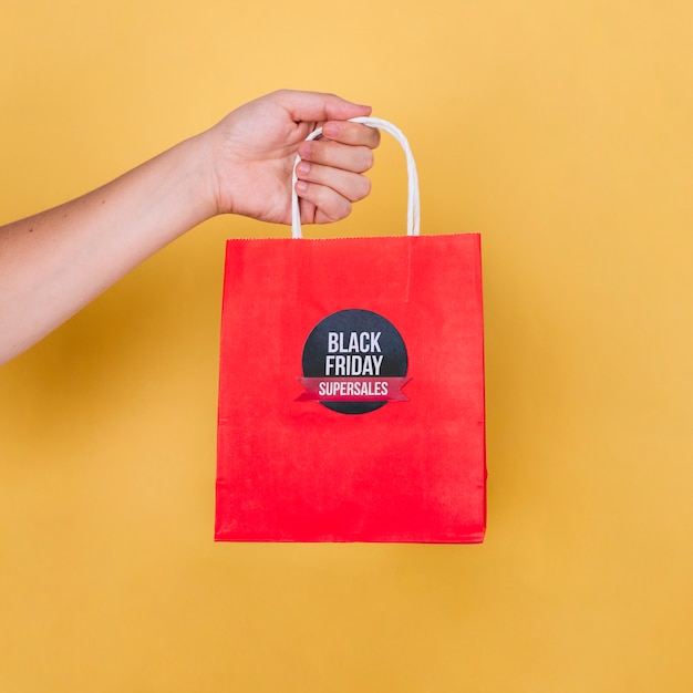 Hand holding black friday bag