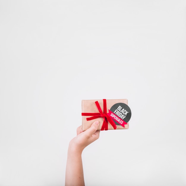 Hand holding black friday gift box