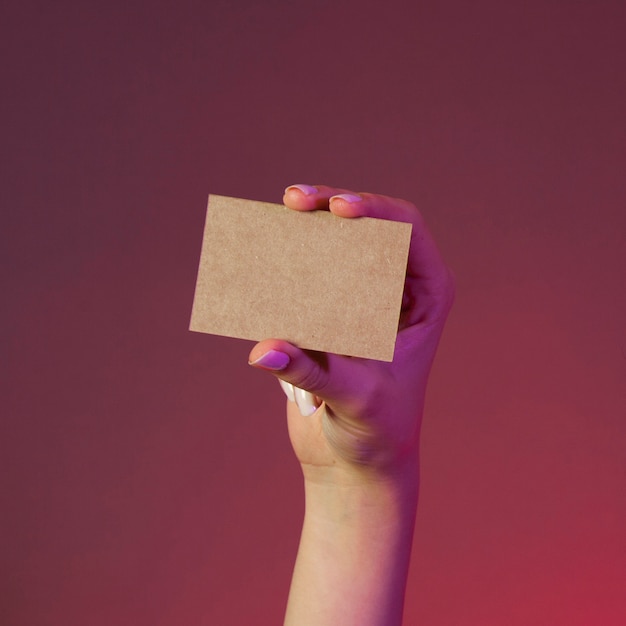 Hand holding blank cardboard business card