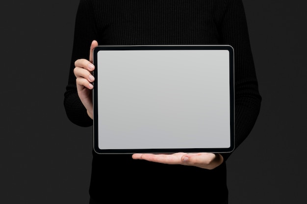 Free photo hand holding blank tablet with design space