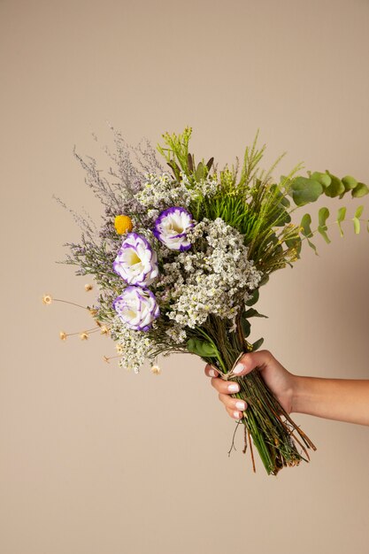 Hand holding boho flowers arrangement