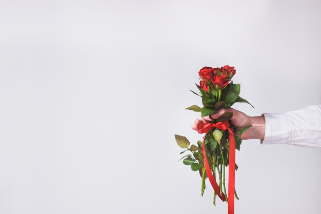 Hand holding a bouquet of roses