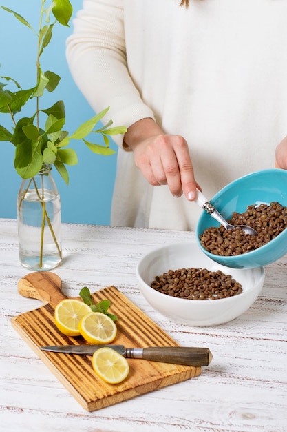 Free photo hand holding bowl with lentils close up