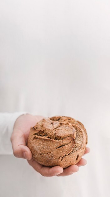 Hand holding bread with white background