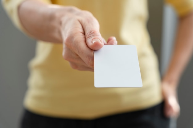 Hand holding business card high angle