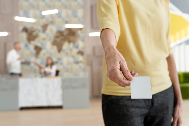 Free photo hand holding business card at work high angle