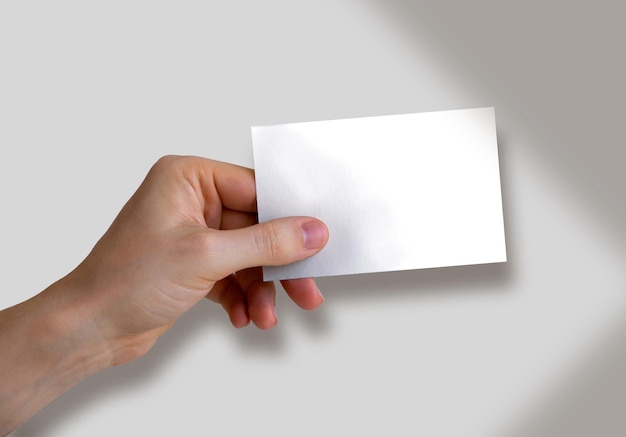 Free photo hand holding a business card