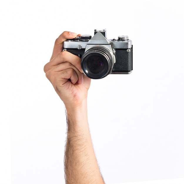 hand holding a camera over white background