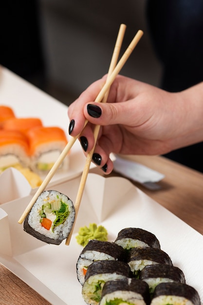 Hand holding chopsticks side view