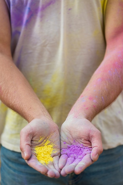 Hand holding colors at holi close-up