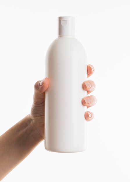 Hand holding cosmetic bottle