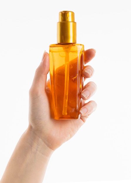 Hand holding cosmetic bottle