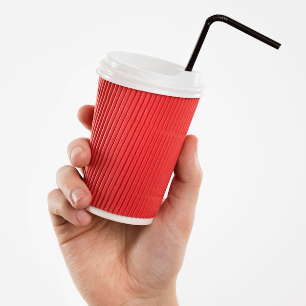 Hand holding cup with straw