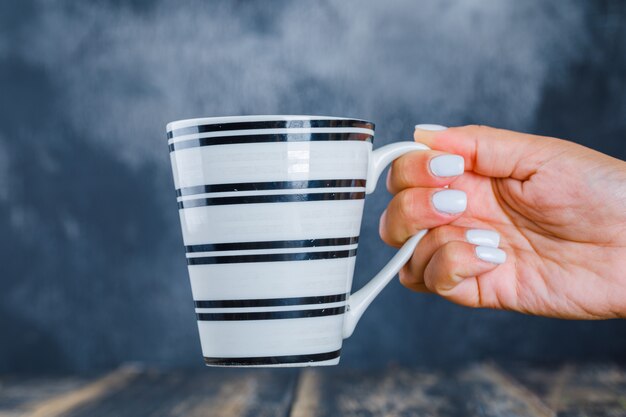 Hand holding cup