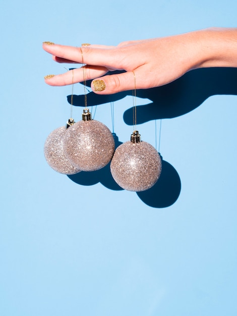 Free photo hand holding decoration balls