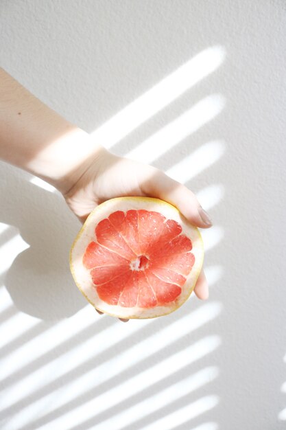 Hand holding a delicious grapefruit