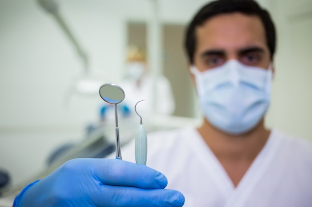 Hand holding dental tools