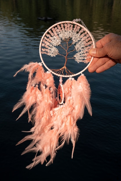 Hand holding dream catcher outdoors