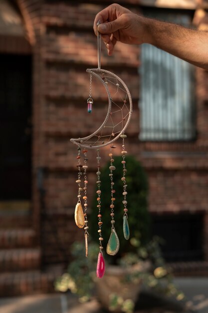 Hand holding dream catcher outdoors