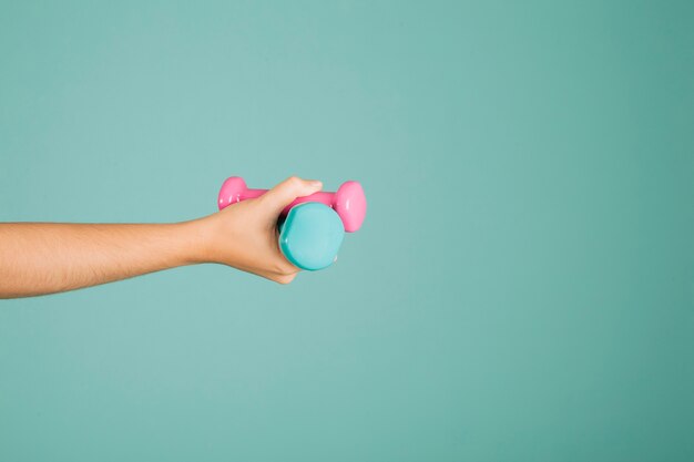 Hand holding dumbbells