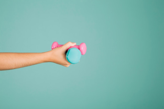 Hand holding dumbbells