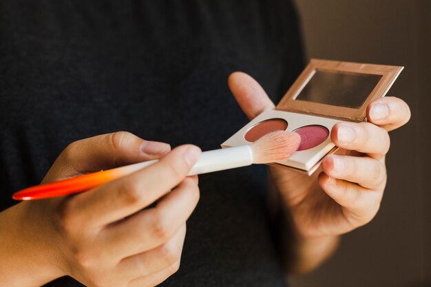 Hand holding eye shadow palette