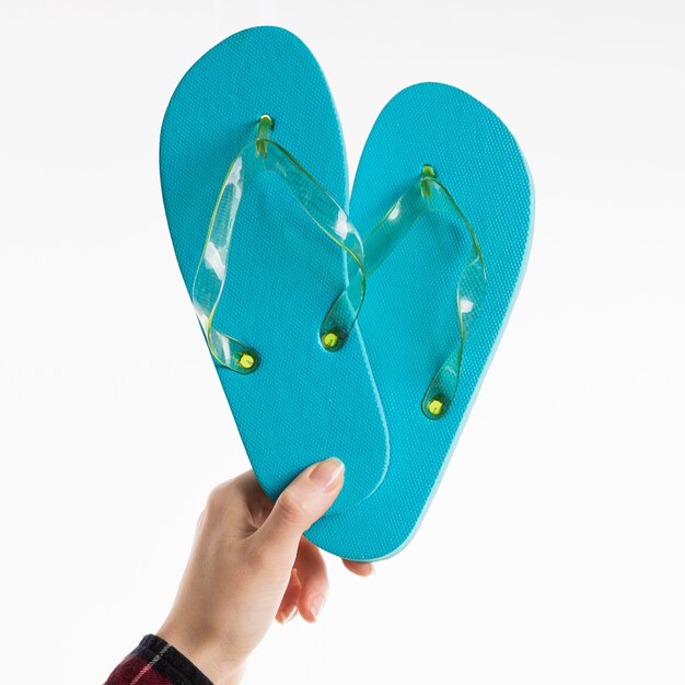 Hand holding flip-flops