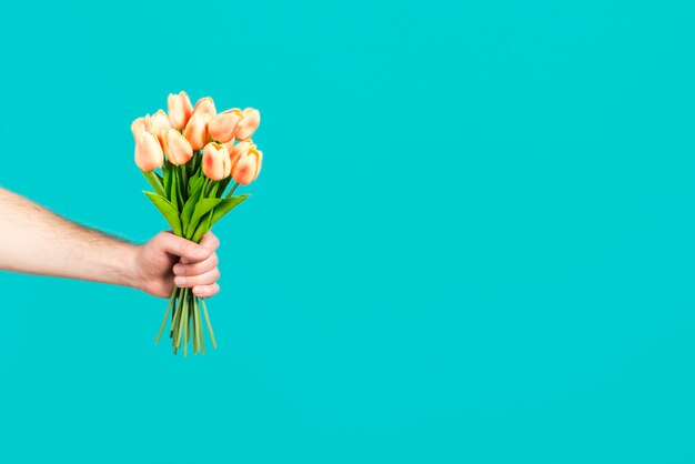 Hand holding flower bouquet