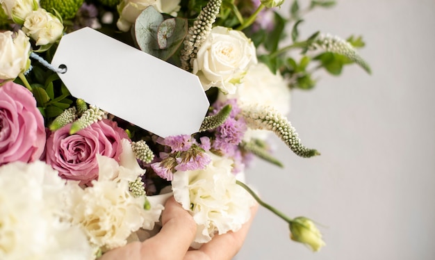 Hand holding flowers bouquet close up