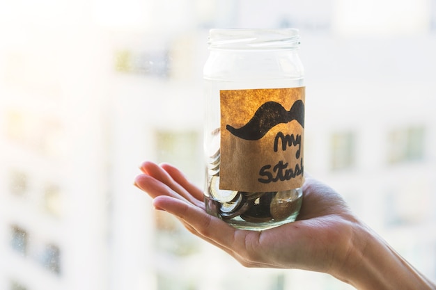 Hand holding glass jar for stash