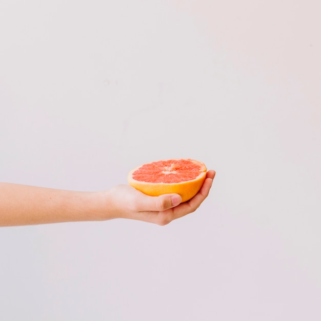 Hand holding grapefruit