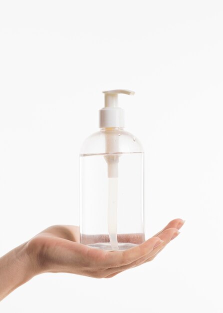 Hand holding hand sanitizer bottle