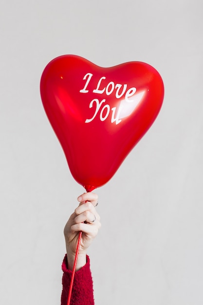 Hand holding i love you balloon